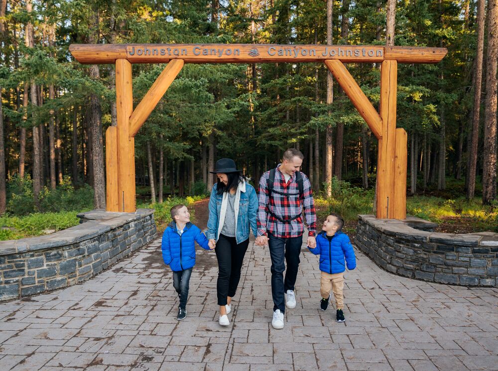 A family walks out of the Johnston Canyon trail in Banff National Park.